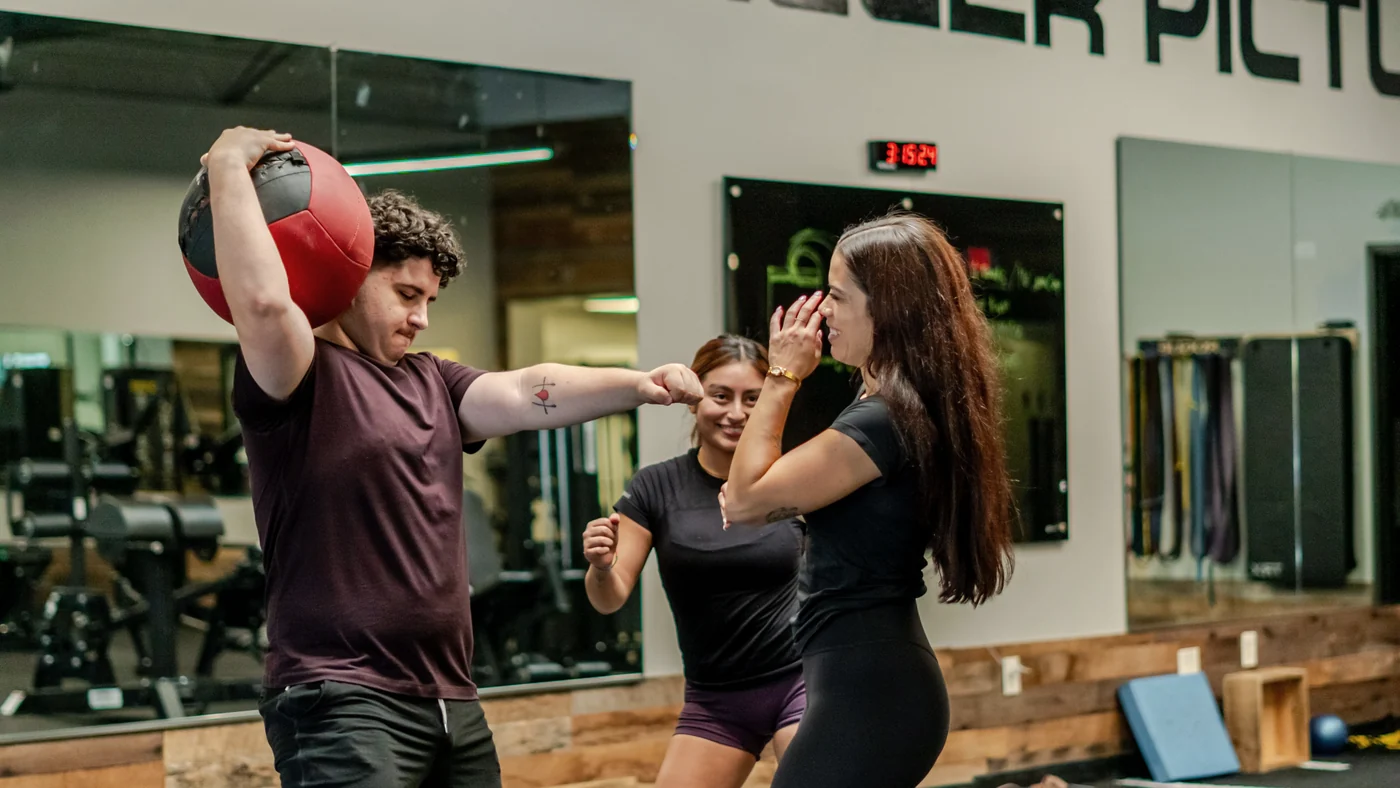 Client celebrating progress during a training session